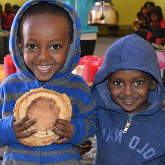 Two happy boys holding nutritious food